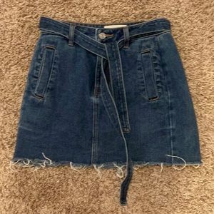 24 inch waist (can fit a 26) jean skirt with adjustable toes, pacsun